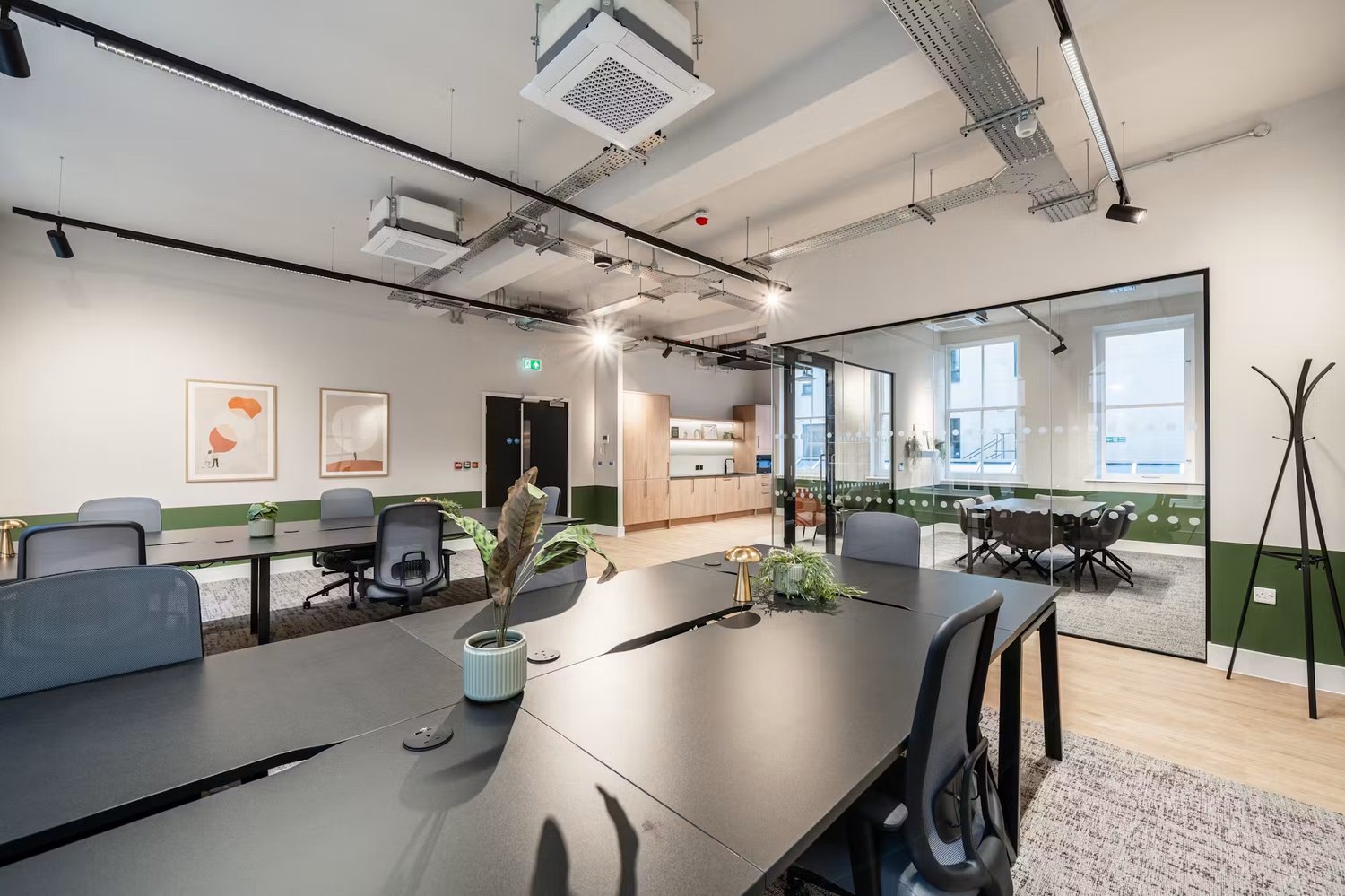 An open layout brings together team desks, meeting space and a dedicated kitchen for a varied working day.