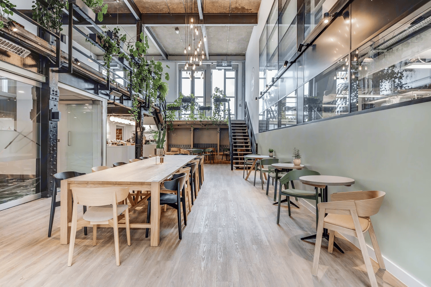 The central atrium at Power Road Studios features the beloved Singer Coffee Bar, and a big family-style table.