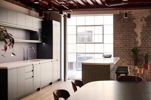 The spacious communal table sits at the heart of the suite, complemented by a fully equipped private kitchenette.